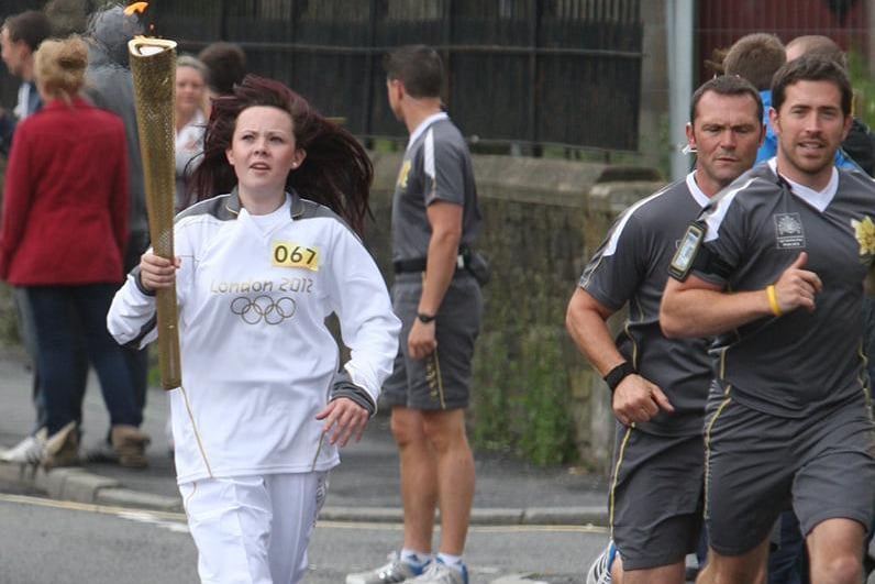 Jade Brindle from Colne carries the Olynpic Torch on Accrington Road.