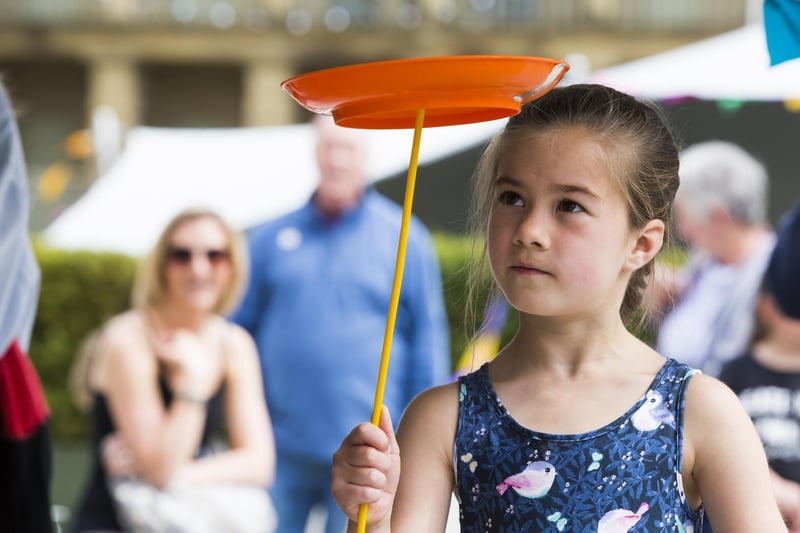 Seven-year-old Jasmine Sladdin gives plate-spinning a try.