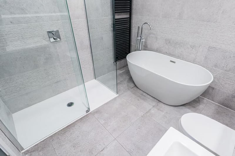 A stylish bath and shower cubicle within one of the house bathrooms