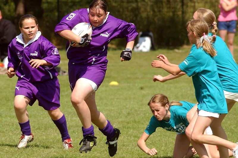 Bradford player Vicky Exley charges past the tackles of the Calderdale players to score a try.