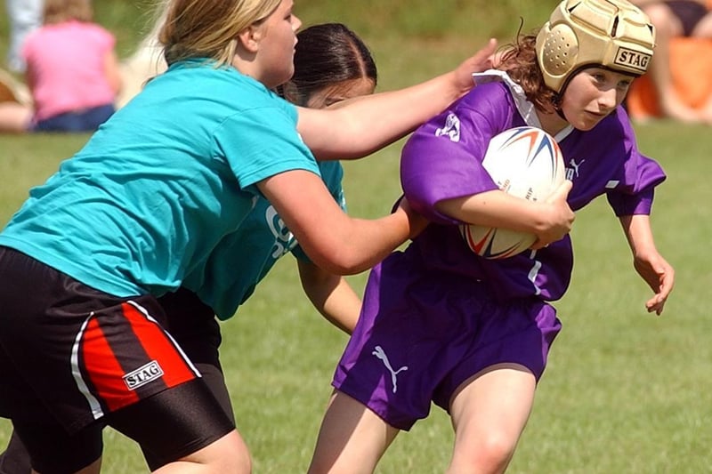 Bradford player Abi Barker charges past the tackles of the Calderdale team.