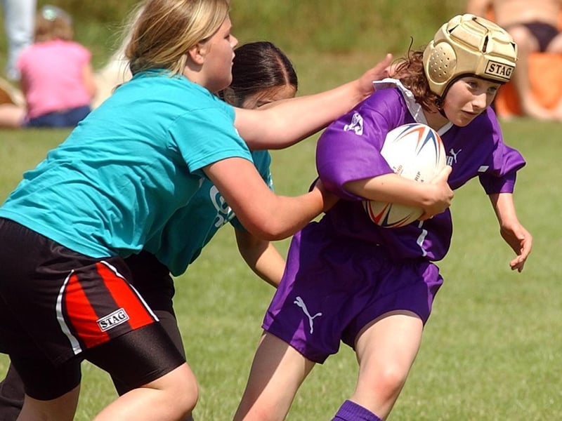 Bradford player Abi Barker charges past the tackles of the Calderdale team.