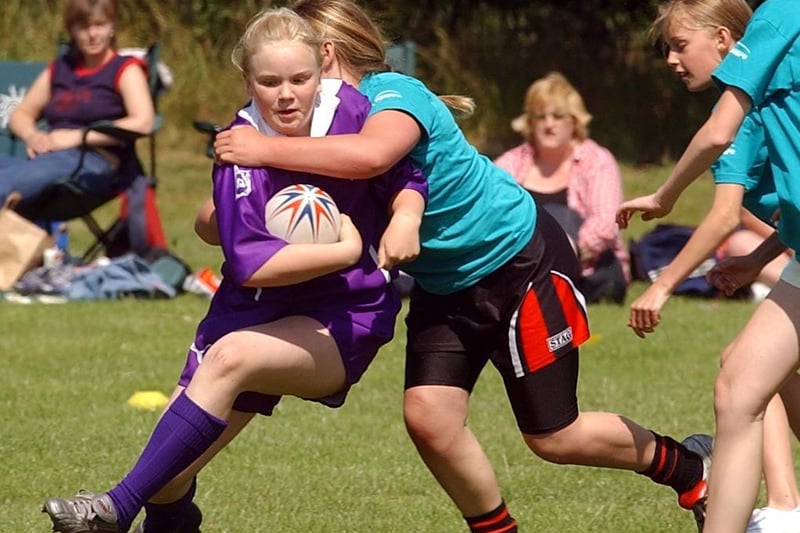 Bradford player Nicola Bartlett is held by a Calderdale player.