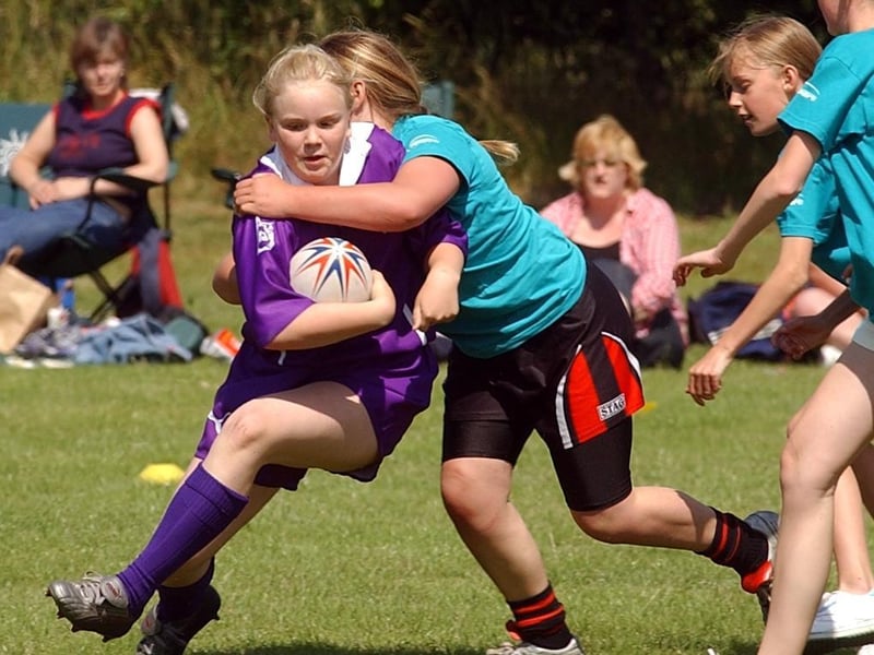 Bradford player Nicola Bartlett is held by a Calderdale player.