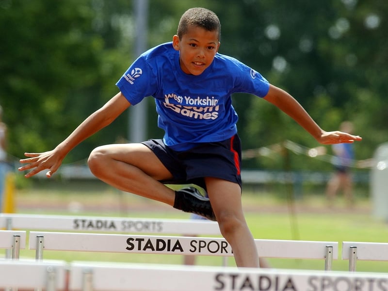Nathan Russell from Leeds wins his heat of the 70 metres hurdles.