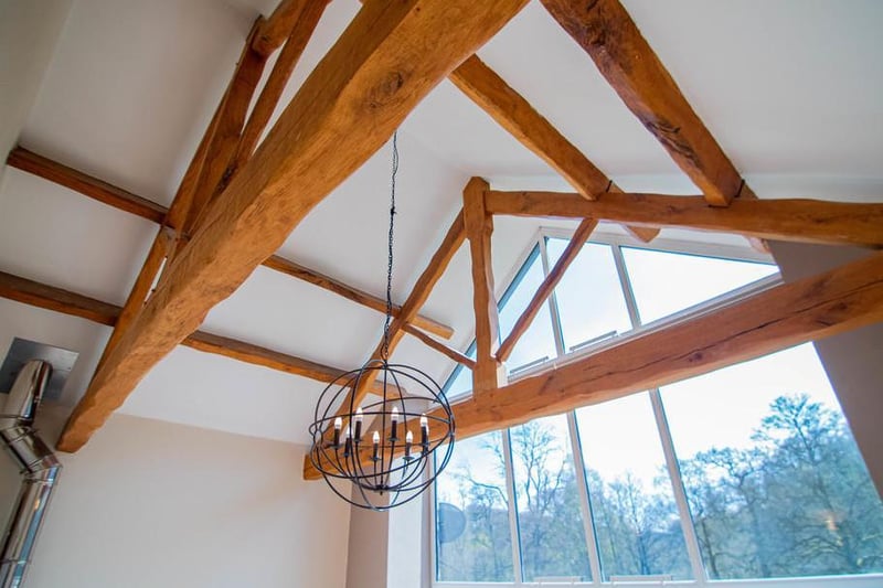 This room also features a comfortable living space with log wood burner and original feature beams. The living room leads out through French patio doors on to an Indian Stone Patio which has stunning views over the grounds.