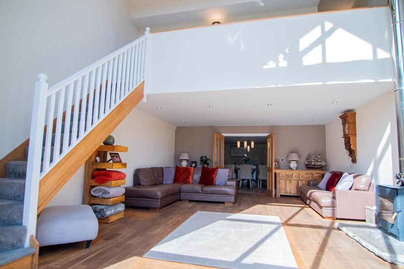 From the living room, there is a stair case which takes you up to the mezzanine and first floor levels of this beautiful home.