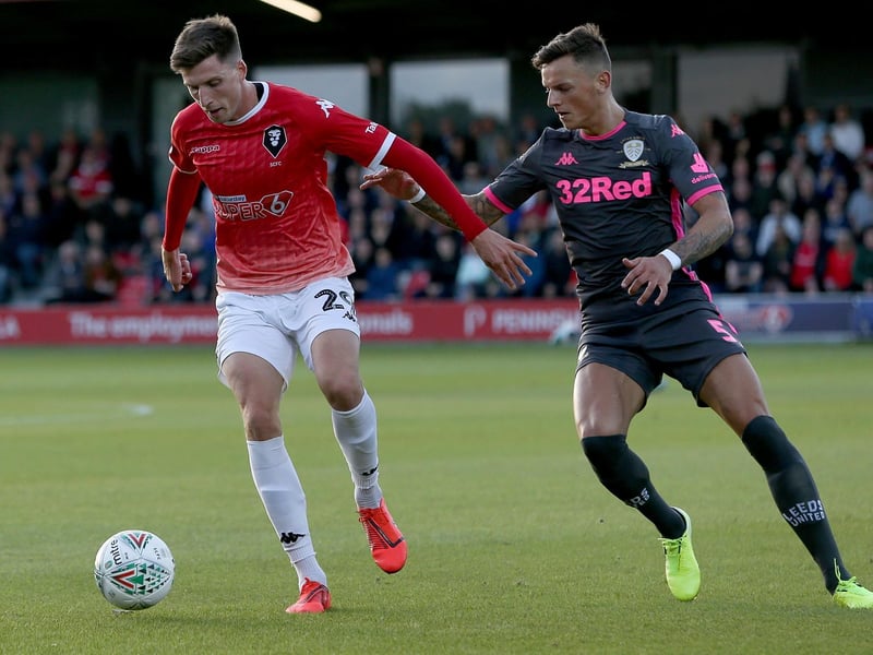 Ben White keeps tabs on Salford City's Jake Beesley.