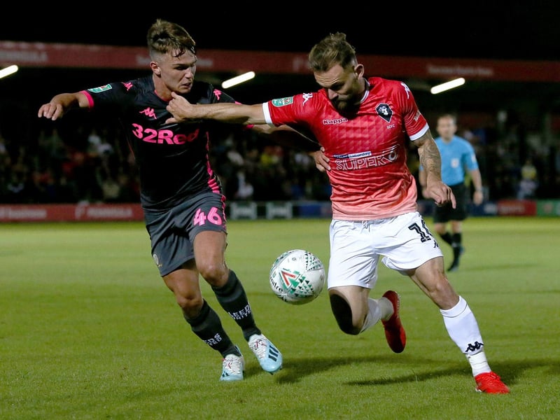 Jamie Shackleton battles for the ball with Salford City's Danny Lloyd-McGoldrick.