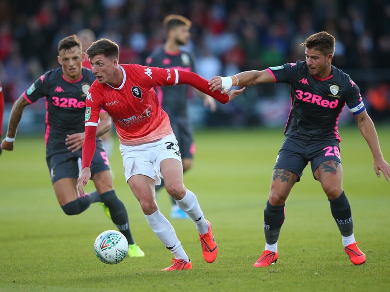 Salford City's Jake Beesley drives forward as Gaetano Berardi challenges.