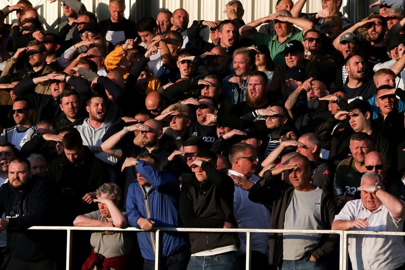 The travelling faithful shield their eyes from the sun.
