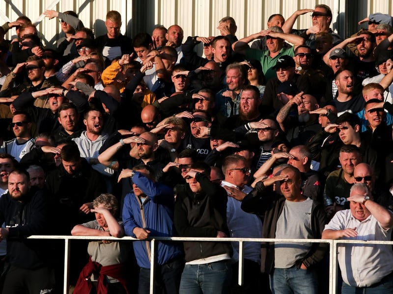 The travelling faithful shield their eyes from the sun.
