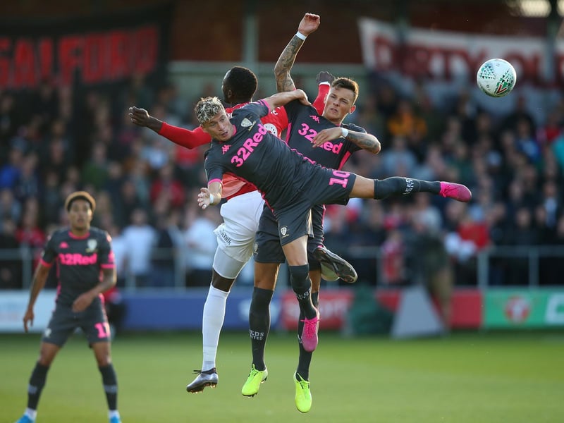 Salford City's Mani Dieseruvwe is challenged by Ezgjan Alioski and Ben White.