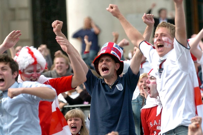 Fans celebrate after Wayne Rooney put England 1-0 ahead against Switzerland.