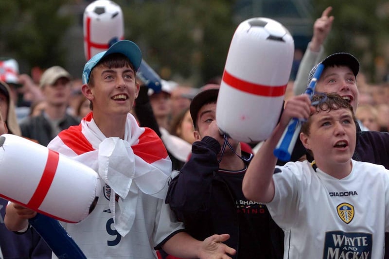 England fans in Millennium Square celebrate Michael Owen's early goal against Portugal.
