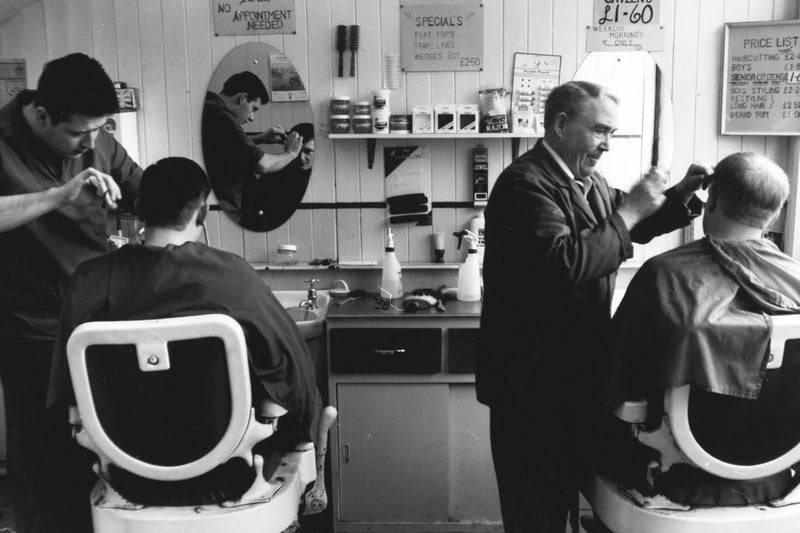 Jack Grafton and grandson Philip Grimes are pictured hard at work in their Holbeck barber's shop in March 1992