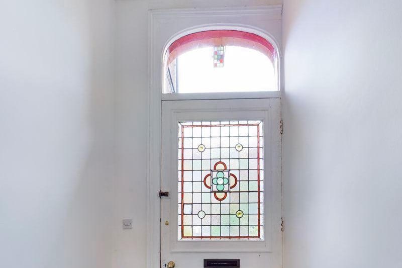 Retaining much of its period character and charm throughout, it includes two large original feature windows on separate floors, in addition to an impressive Victorian stained glass front door.