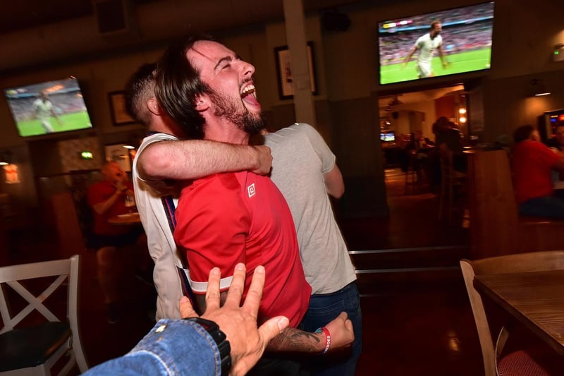 Fans react at The Scarborough Flyer as Harry Kane nods home England's second goal.