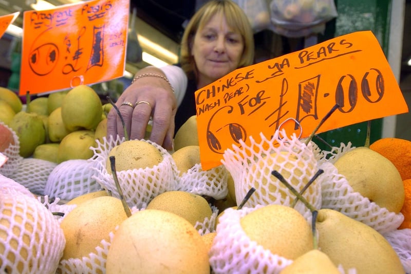 Reaching for Chinese Pears on Mike's fruit and veg stall.