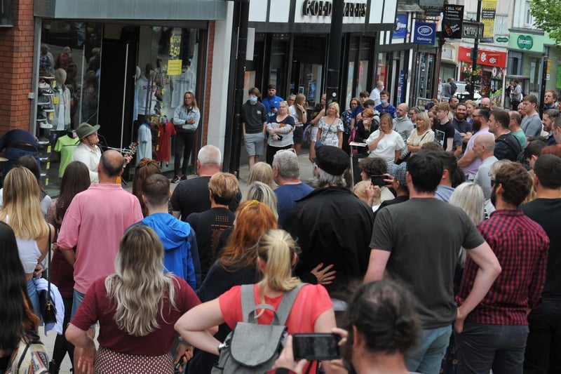A large crowd gather in Wigan town centre to see the local band.