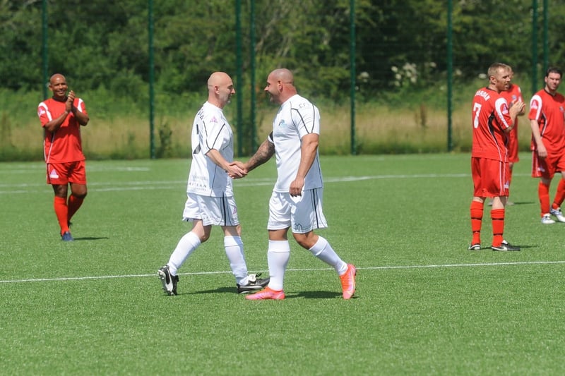 Matt Banks, Jordan's dad, (right) shakes hands with his teammate at the charity match organised in memory of his son.