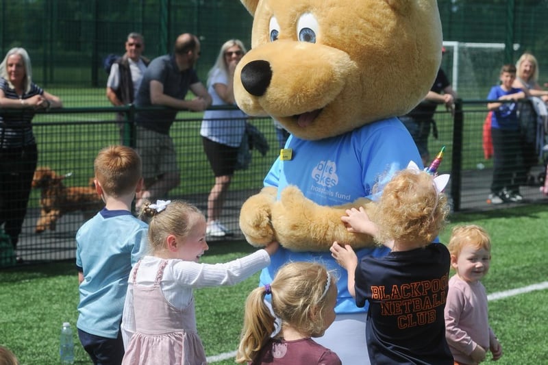 Youngsters have fun with Bobby Bear, Blue Skies' mascot.