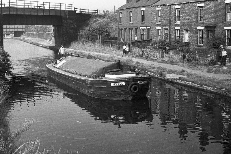 A working canal barge delivering  bags of coal to canalside residents for 1 pound and 50 pence in 1976