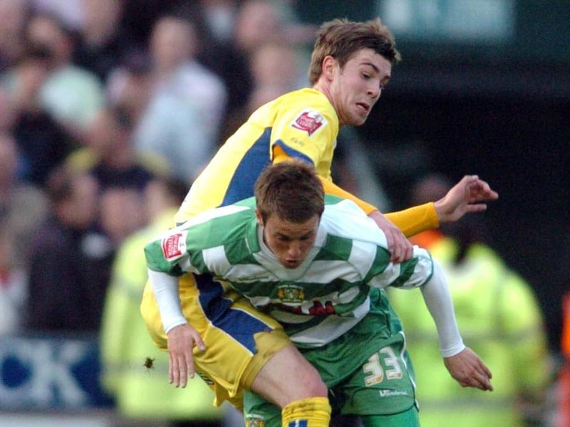 Paul Huntington tangles with Yeovil Town's Aidan Downes.