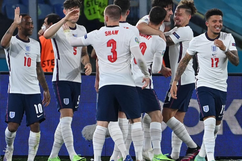 Phillips, second right, celebrates with goal scorer Harry Maguire after England go 2-0 up in their quarter final against Ukraine in Rome.