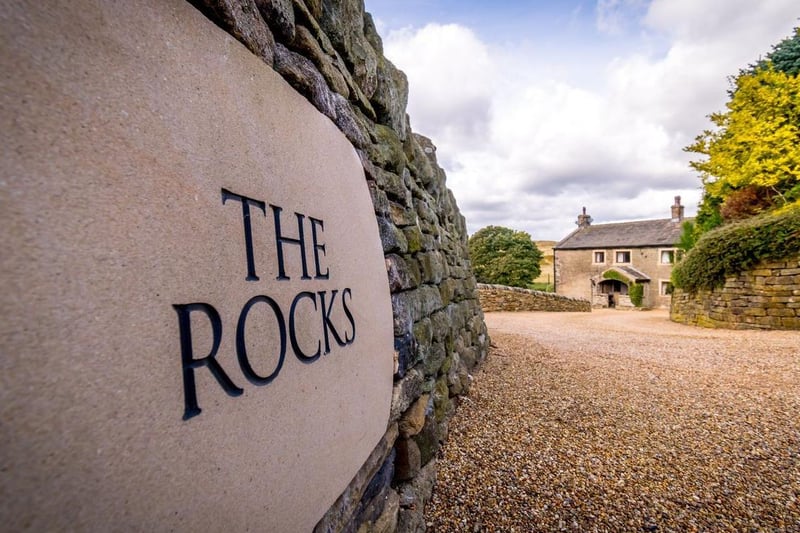 House name on a stone wall leading up to The Rocks