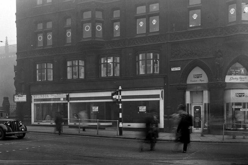 Royal Exchange Building on east side of Park Row next to Boar Lane in December 1951. Cosmetique ladies hairdressers, Albert Cowling wine lodge, Melindon fabric specialists and Kings cleaners and dyers visible