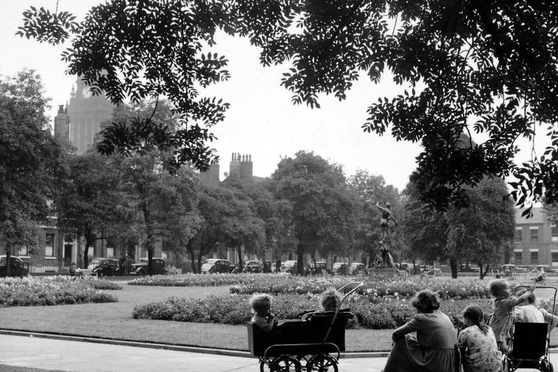 Park Square on a summer's day in August 1951 where a woman and several children are relaxing.