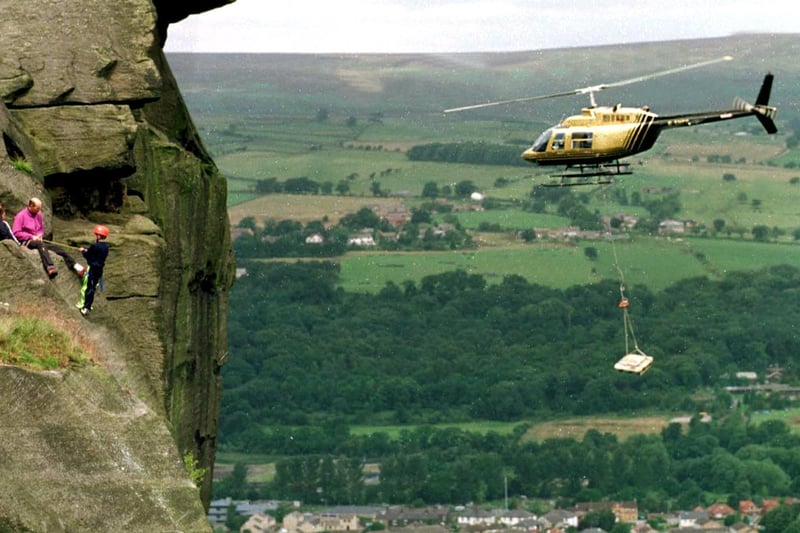 A helicopter begins to task of carrying stone slabs to the top of the moor at the Cow & Calf in July 1998. The stone was being used to create footpaths to halt erosion.