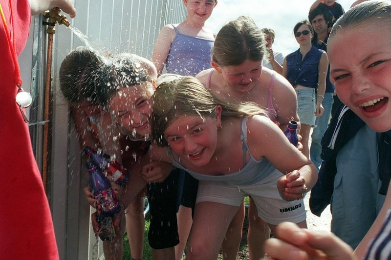 These girls - Stacy Lasota, Leanne Lewis and Amy Lasota -  are pictured cooling off at Party in the Park in July 1999.