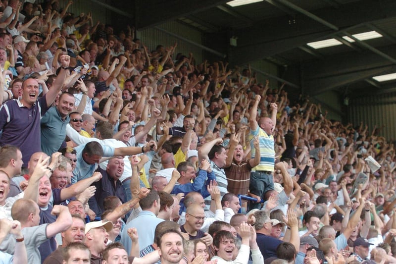 The travelling support celebrate at full-time.