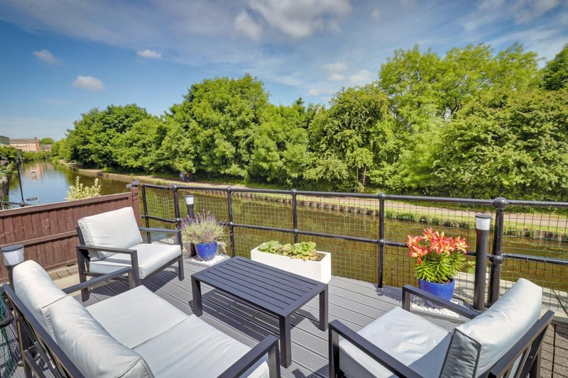 To the rear of the property is the magnificent terrace and deck, which takes advantage of its views across the canal.