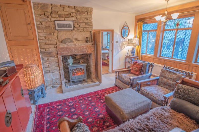 The sitting room is warmed by a wood-burning stove