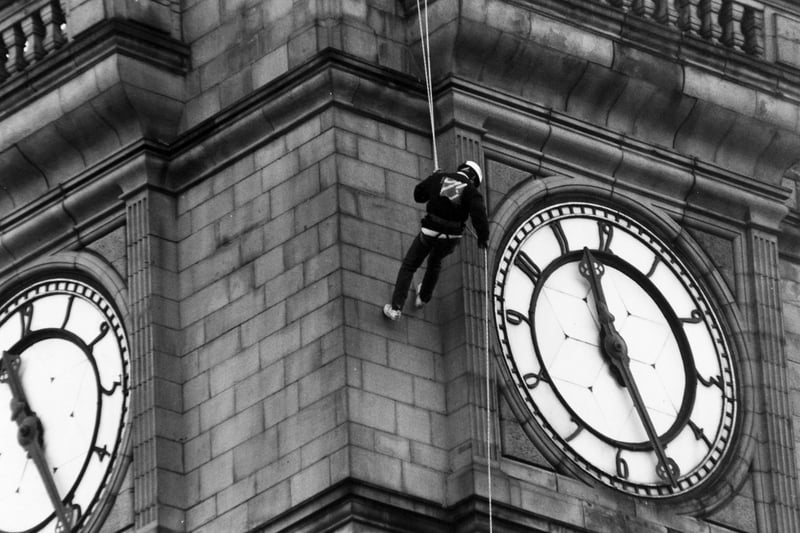 Simon Young is pictured abseiling down Leeds Town Hall's clock tower in November 1993. He was aiming to raise public awareness of local youth activity.