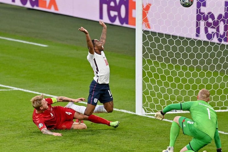 Simon Kjaer of Denmark scores an own goal, England's first goal, whilst under pressure from Raheem Sterling of England