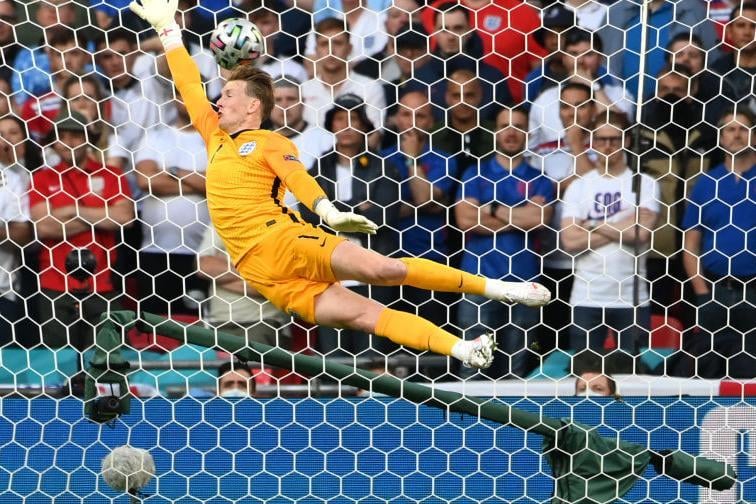 England's goalkeeper Jordan Pickford concedes a goal during the UEFA EURO 2020 semi-final football match between England and Denmark