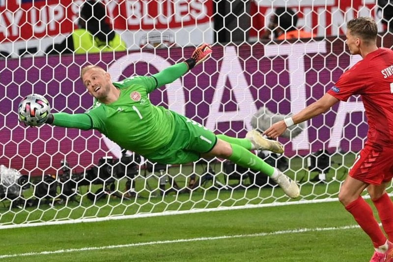 Denmark's goalkeeper Kasper Schmeichel (L) saves a shot