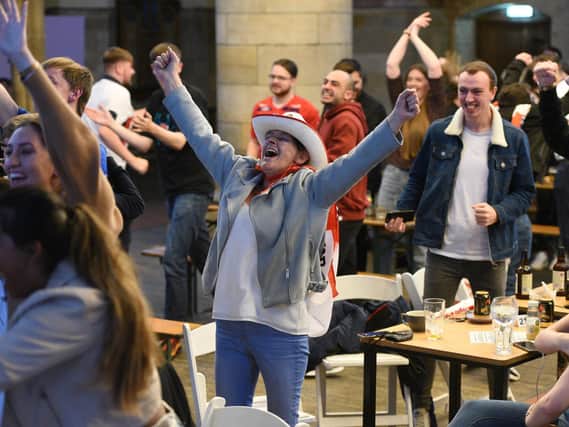 Cheering fans celebrate as England beat Denmark 2-1. (Guzelian)