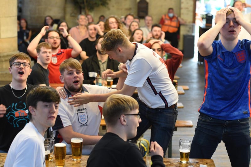 Fans rue a missed chance for England against Denmark in the semi finals of Euro 2020 as they watch on a large screen at at the Left Bank community centre.