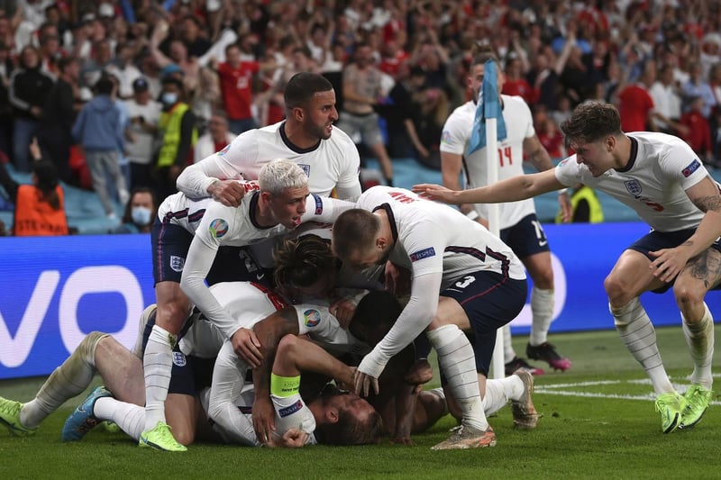 England's Harry Kane, bottom, celebrates with his teammates after scoring his side's second goal during. (Laurence Griffiths/Pool Photo via AP)
