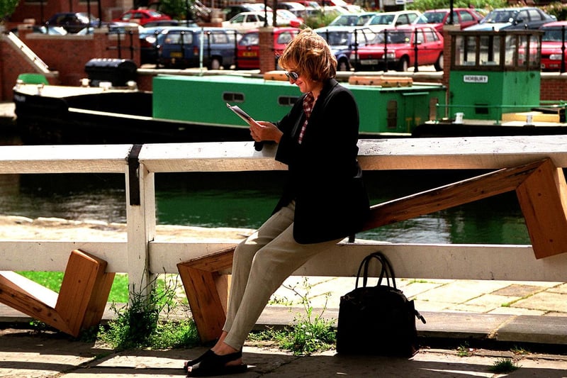 A member of the public manages to get comfortable on the 'unsittable seat' on the canalside at Granary Wharf.