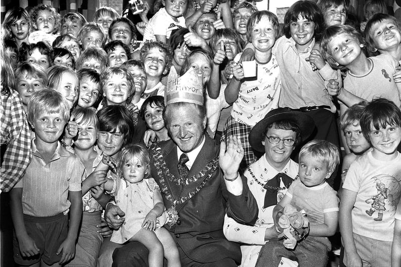 Mayor of Wigan, CounJoseph Albert Eckersley, is pictured centre with excited members of Ince Youth Club enjoying their summer play scheme.in 1976