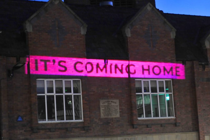 it's coming home - projected onto a building on Market Street, Wigan town centre.