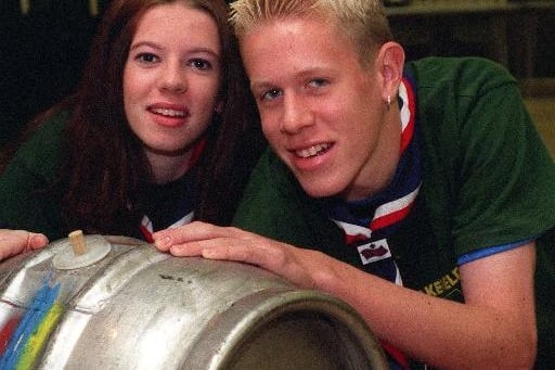 Two of the 15th. Wakefield Scouts who helped prepare the beer festival in Ossett Town Hall to raise funds for the trip to the World Jamboree in Chule in December 1999. Edwina Hyde and Marc Burton roll a barrel into position.
