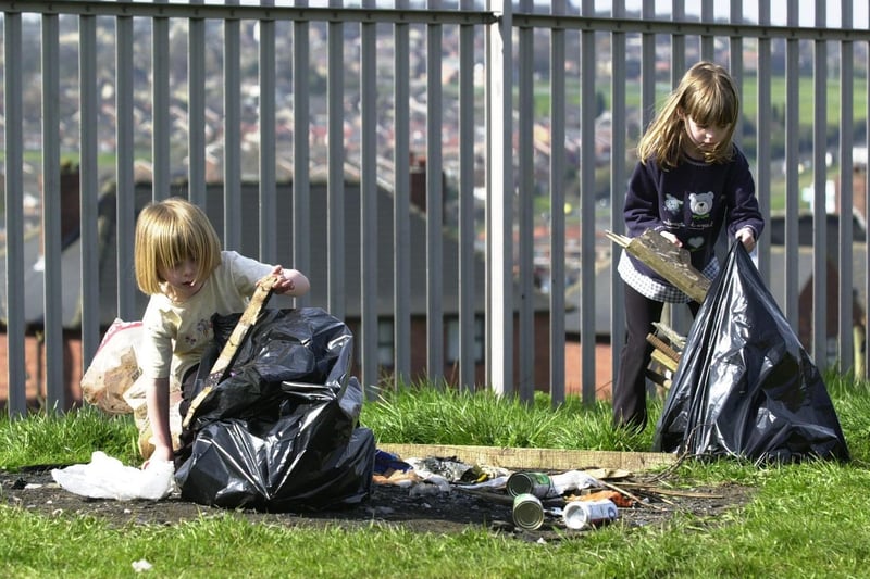 Ammiee (left) and her sister Sarah help clean up the Fairfield estate in April 2001.