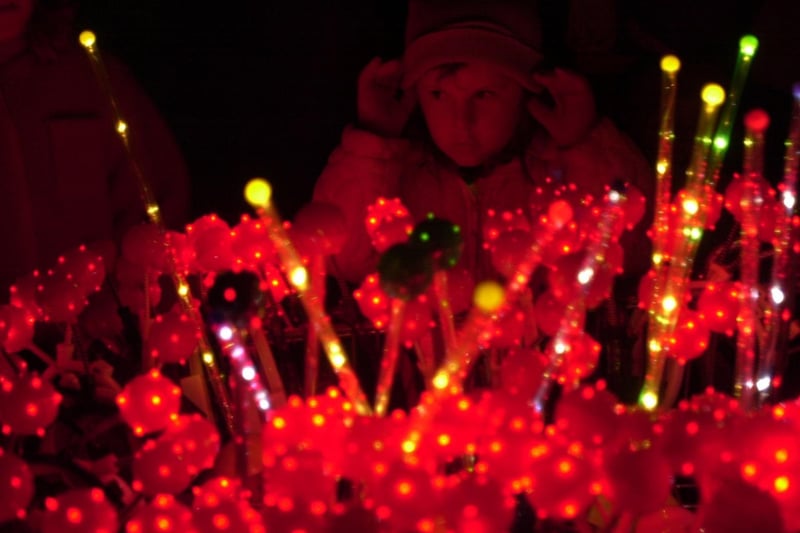 A young girl buys some glowing antlers from a stand at Bramley Bonfire in November 2001.